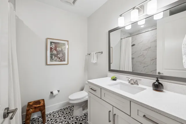 a bathroom with a sink toilet and a mirror