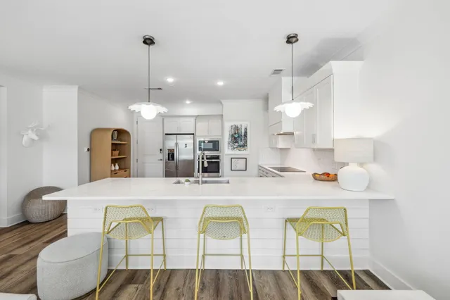 a large kitchen with a table and chairs