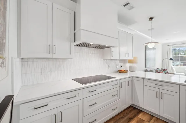 a kitchen with white cabinets and white appliances