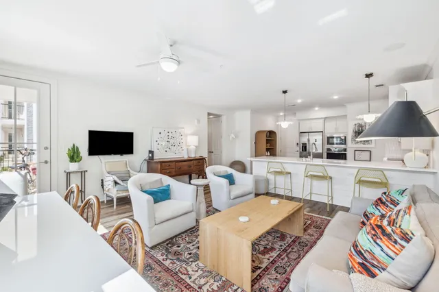 a living room with furniture wooden floor and a flat screen tv