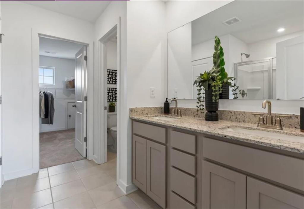 74 Poplar Blf Way Jefferson, GA 30549 - Photo 25 of 32 a bathroom with a granite countertop sink and a mirror