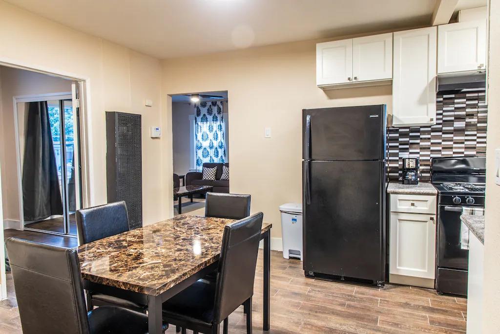 6152 Baker Street Oakland, CA 94608 - Photo 12 of 23 a kitchen with stainless steel appliances granite countertop a refrigerator and a stove top oven