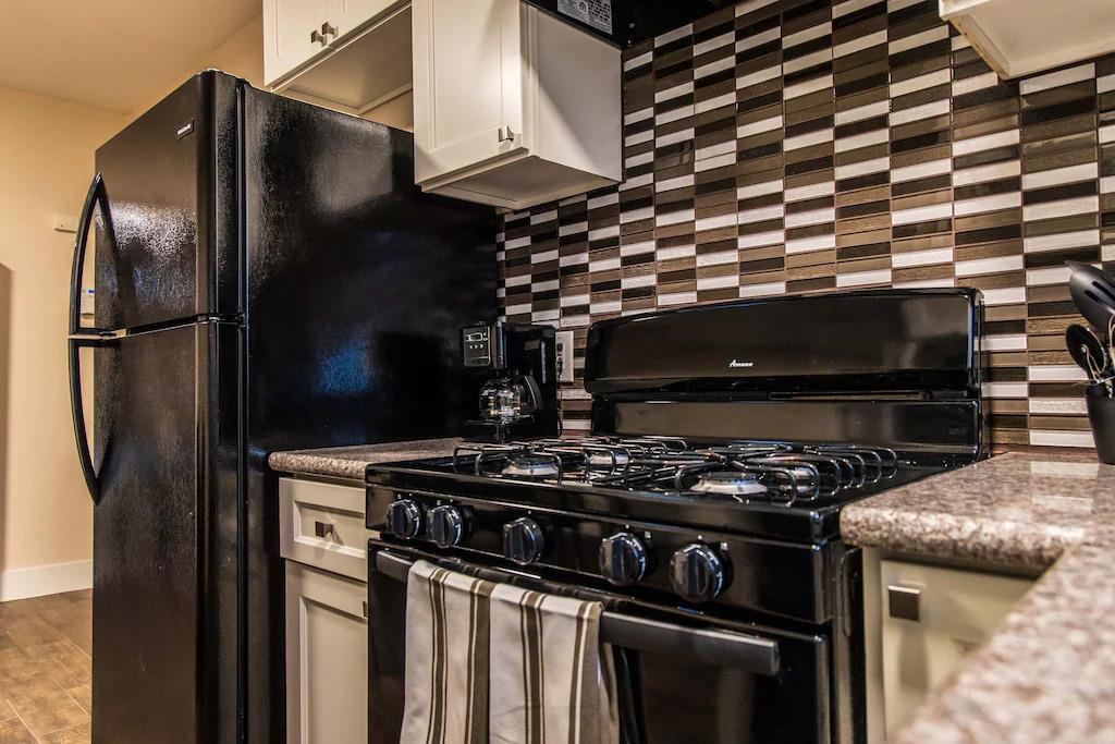6152 Baker Street Oakland, CA 94608 - Photo 14 of 23 a close view of a stove top oven and refrigerator