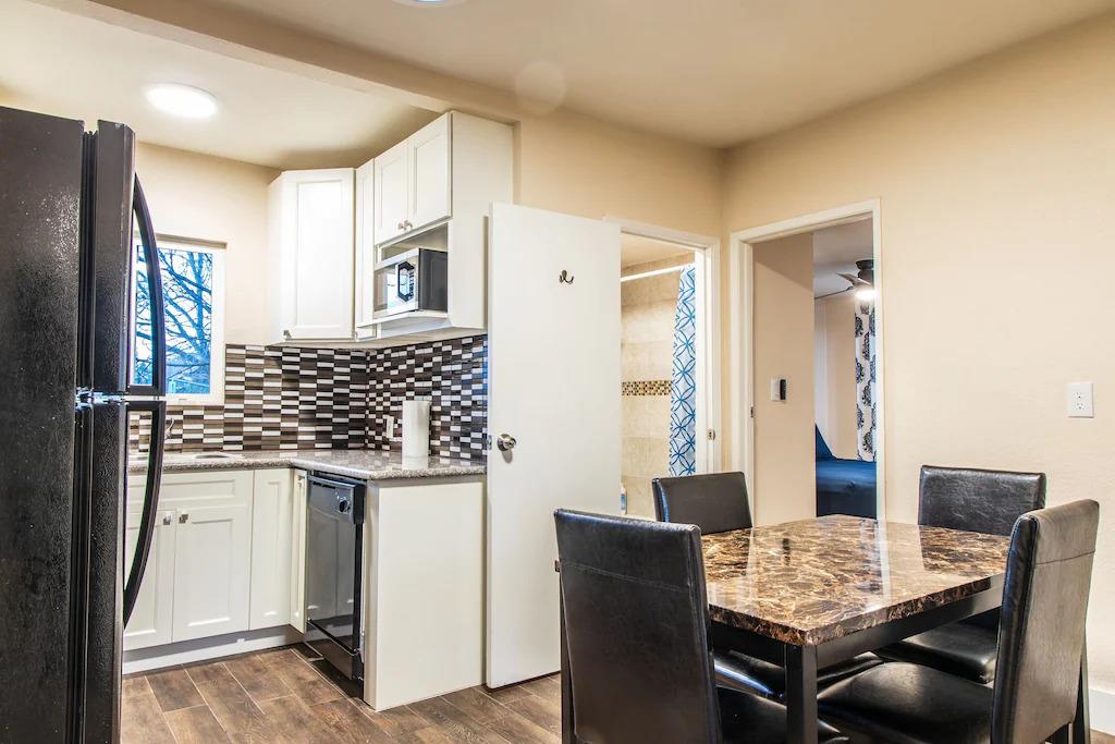 6152 Baker Street Oakland, CA 94608 - Photo 15 of 23 a view of kitchen with granite countertop dining table chairs and granite counter top