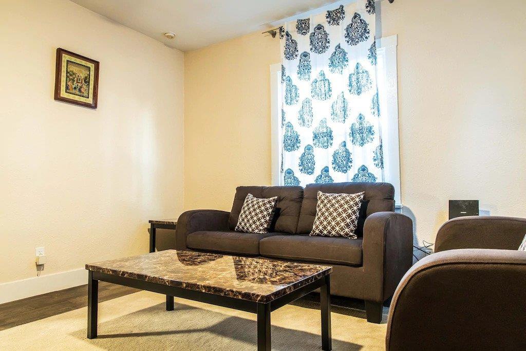 6152 Baker Street Oakland, CA 94608 - Photo 17 of 23 a living room with furniture and a wooden floor