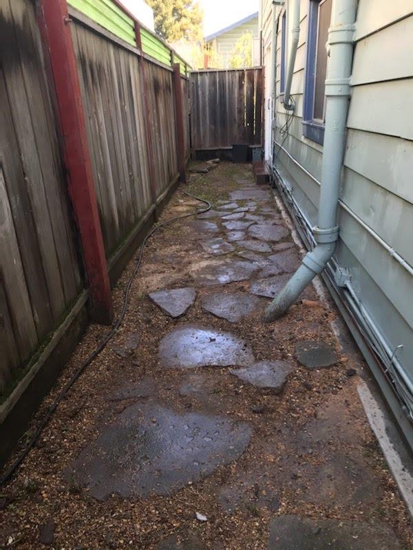 6152 Baker Street Oakland, CA 94608 - Photo 21 of 23 a view of a backyard with a wooden fence