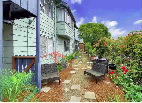 6152 Baker Street Oakland, CA 94608 - Photo 3 of 23 a backyard of a house with outdoor seating