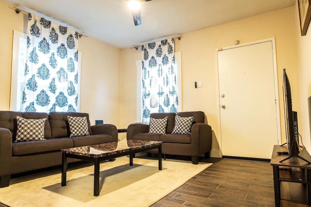 6152 Baker Street Oakland, CA 94608 - Photo 6 of 23 a living room with furniture and a flat screen tv