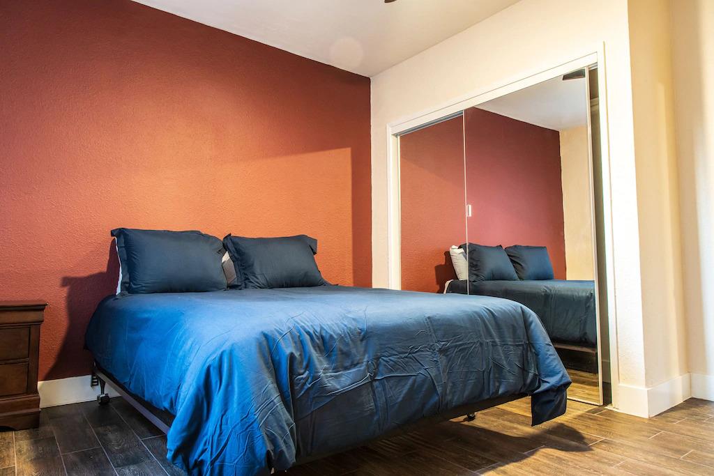 6152 Baker Street Oakland, CA 94608 - Photo 7 of 23 a bedroom with a bed and wooden floor