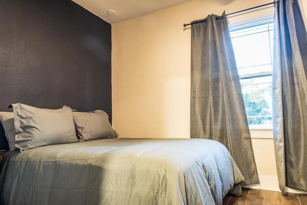 6152 Baker Street Oakland, CA 94608 - Photo 10 of 23 a bedroom with a bed and a window