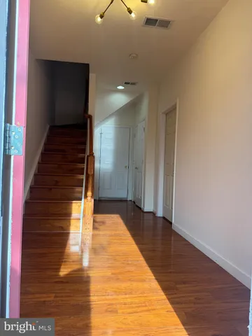 a white toilet sitting next to a sink and a mirror