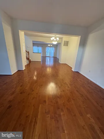 a view of a room with kitchen island stainless steel appliances sinks stove and cabinets