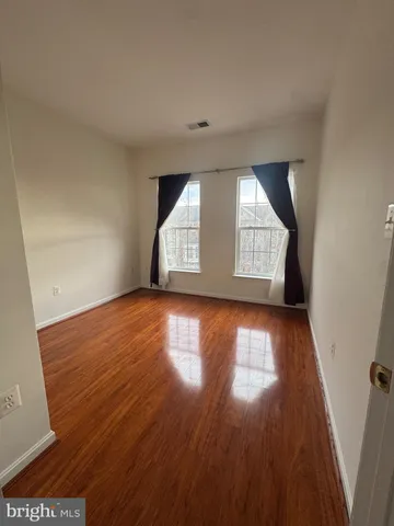 a spacious bathroom with a sink and a mirror