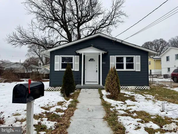 a front view of a house with a yard covered in snow