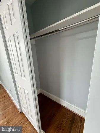 a view of closet with wooden floor