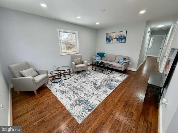 a living room with furniture and a rug