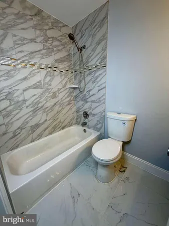 a bathroom with a toilet and a bath tub