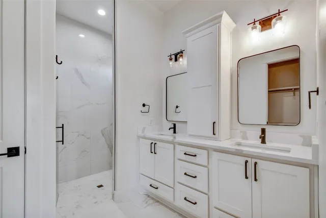 a bathroom with a double vanity sink mirror and double