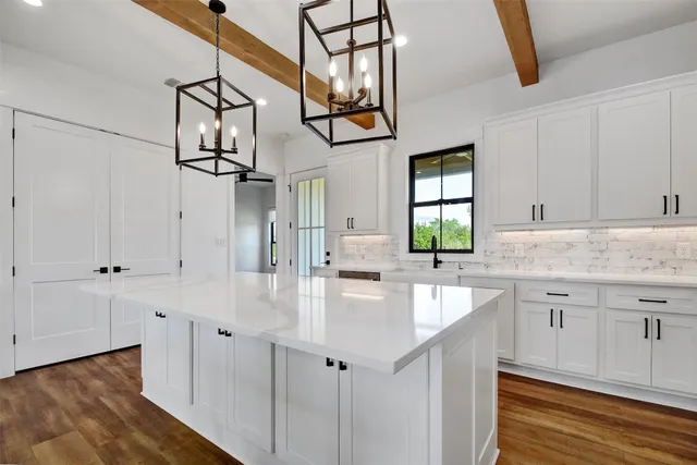 a kitchen with stainless steel appliances granite countertop a sink and dishwasher with wooden floor