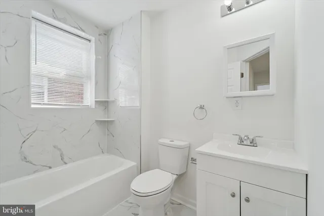 a bathroom with a sink a toilet and a bathtub