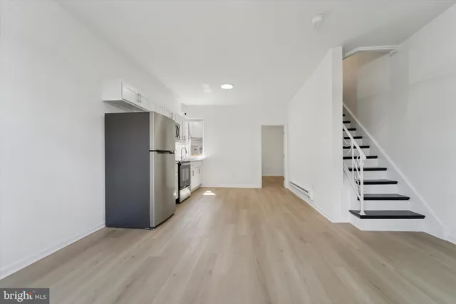 a view of wooden floor and entryway in a room