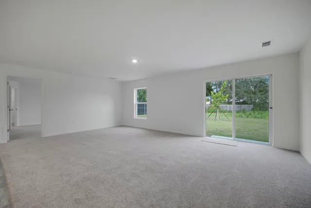 a view of a kitchen with white cabinets and a sink