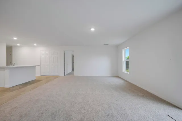 a view of a kitchen with a sink and a refrigerator