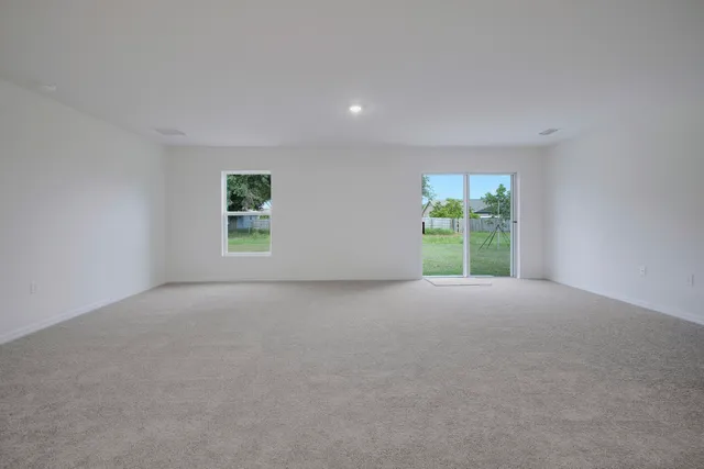 a kitchen with stainless steel appliances kitchen island granite countertop a stove a sink and a refrigerator