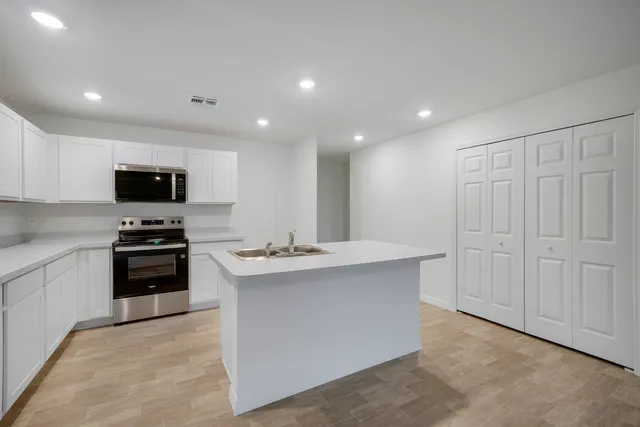 a utility room with sink dryer and washer