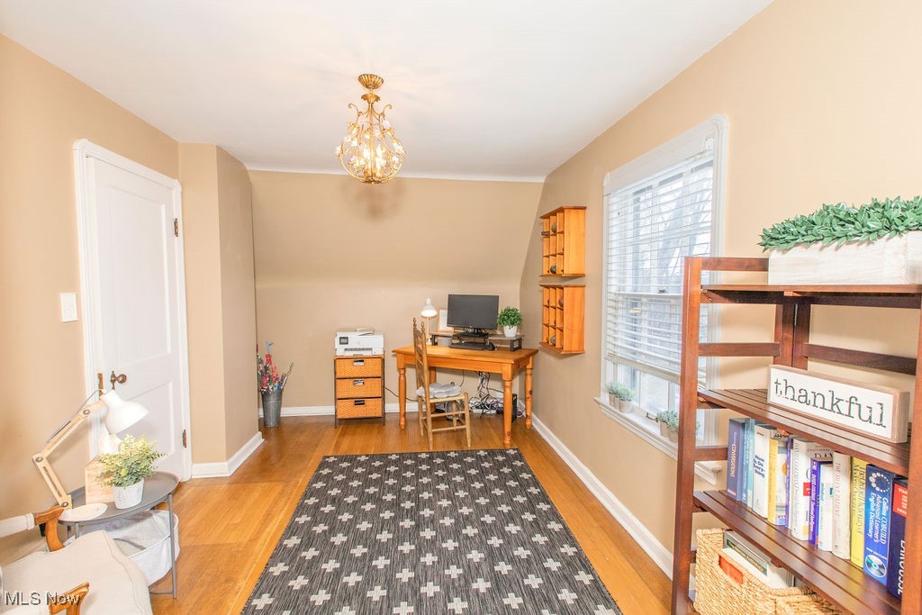 1528 Oakmount Road South Euclid, OH 44121 - Photo 18 of 24 Second bedroom being used as an office with hardwood floors and a chandelier.