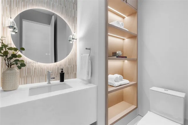 a en suite bathroom with a sink and mirror