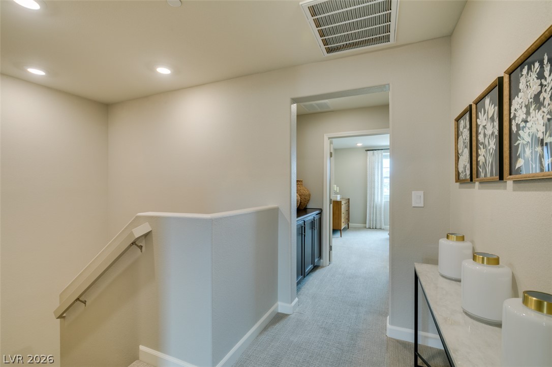 653 Pickled Pepper Place Henderson, NV 89011 - Photo 20 of 35 Recessed lighting illuminates a comfortable hallway leading to private quarters.