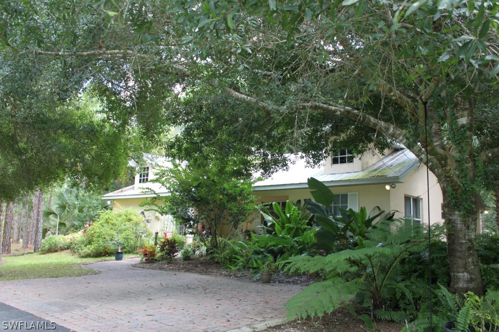 4091 Staley Road Fort Myers, FL 33905 - Photo 1 of 17 a view of a white house with a yard and plants