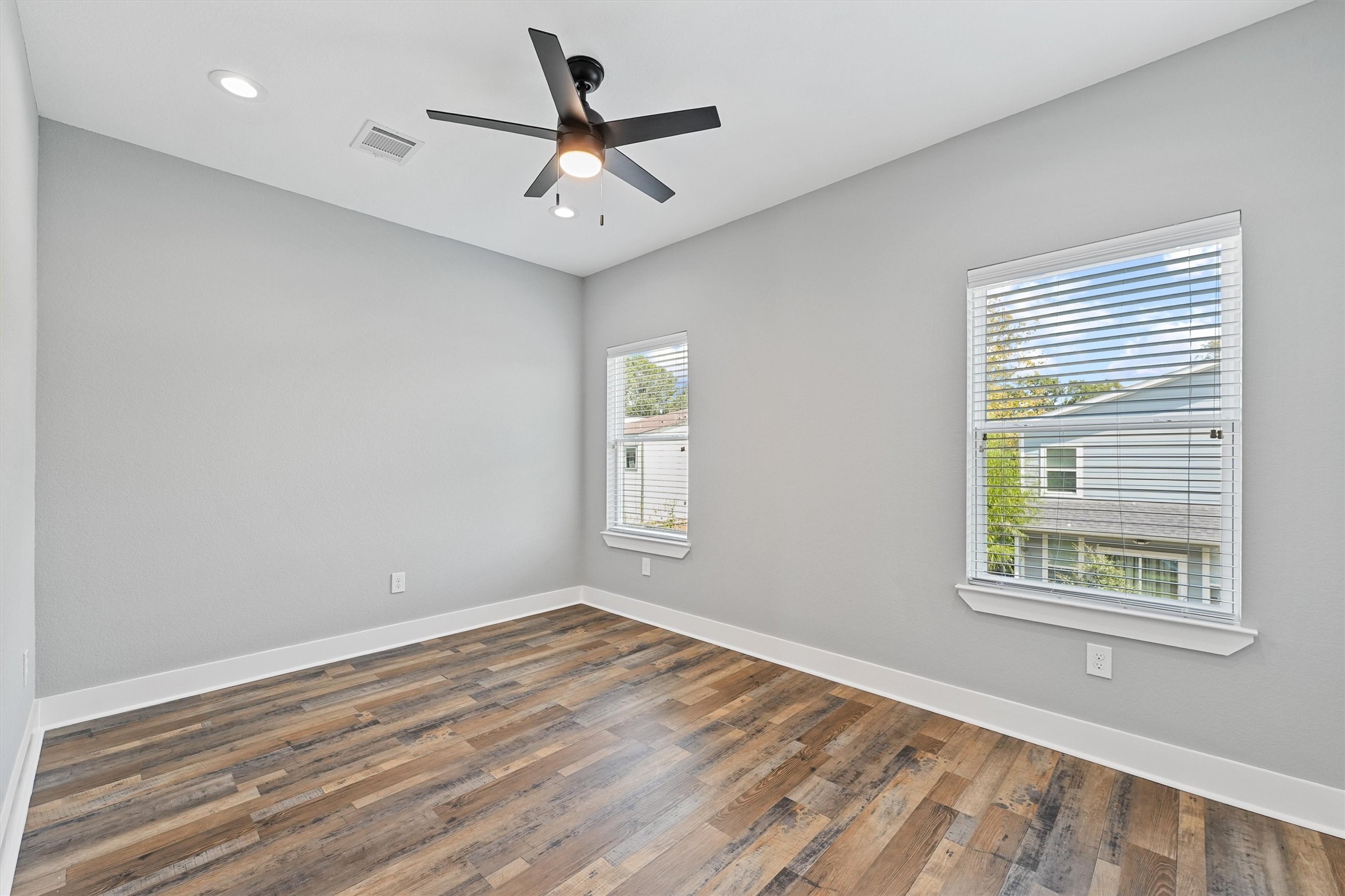 7704 Sealey Street Houston, TX 77088 - Photo 11 of 15 a view of a big room with wooden floor and windows
