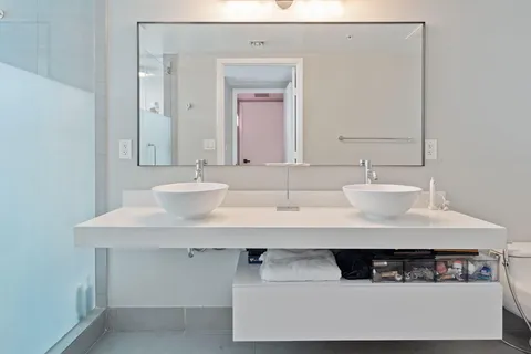 a bathroom with a sink a mirror and a vanity