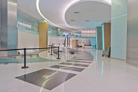 a living room with furniture and large windows