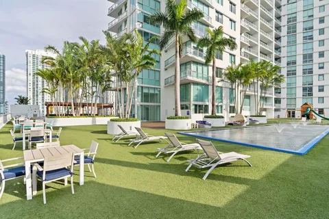 a view of a house with swimming pool and sitting area