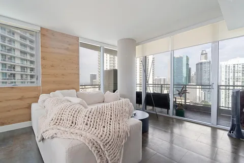 a bedroom with a bed and glass door