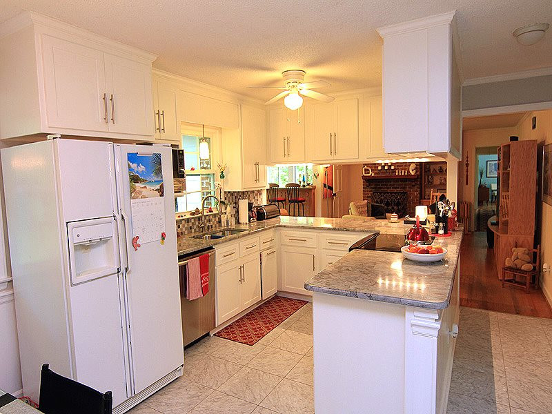8601 Evergreen Court Raleigh, NC 27613 - Photo 11 of 25 Beautifully updated kitchen with granite, tile floor and back splash, SS appliances, new fixtures. Kitchen