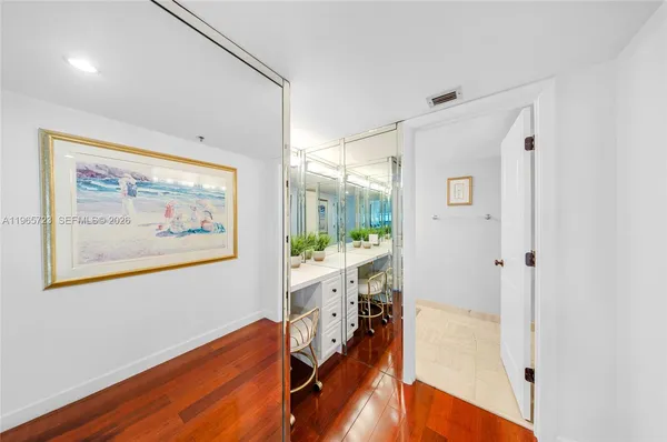 a view of a room with wooden floor and window