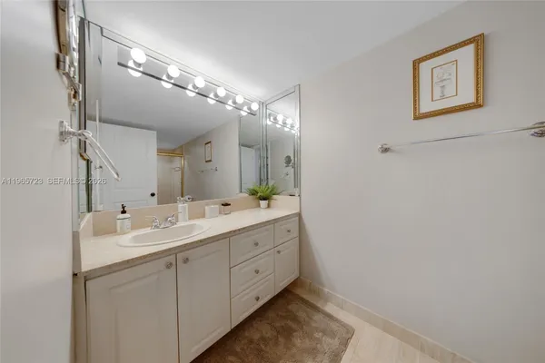 a bathroom with a double vanity sink and a mirror