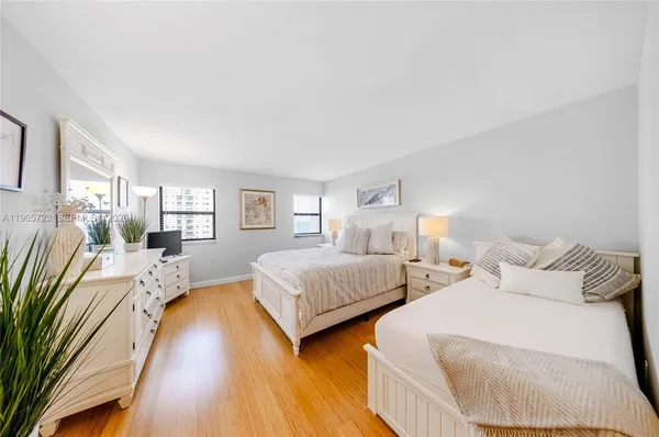 a bedroom with two beds and a couch