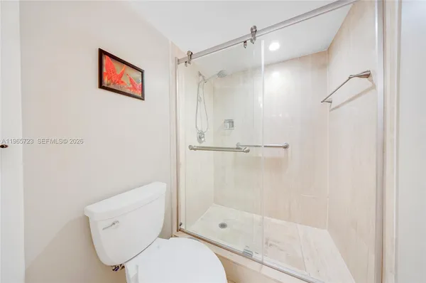 a bathroom with a toilet and a shower