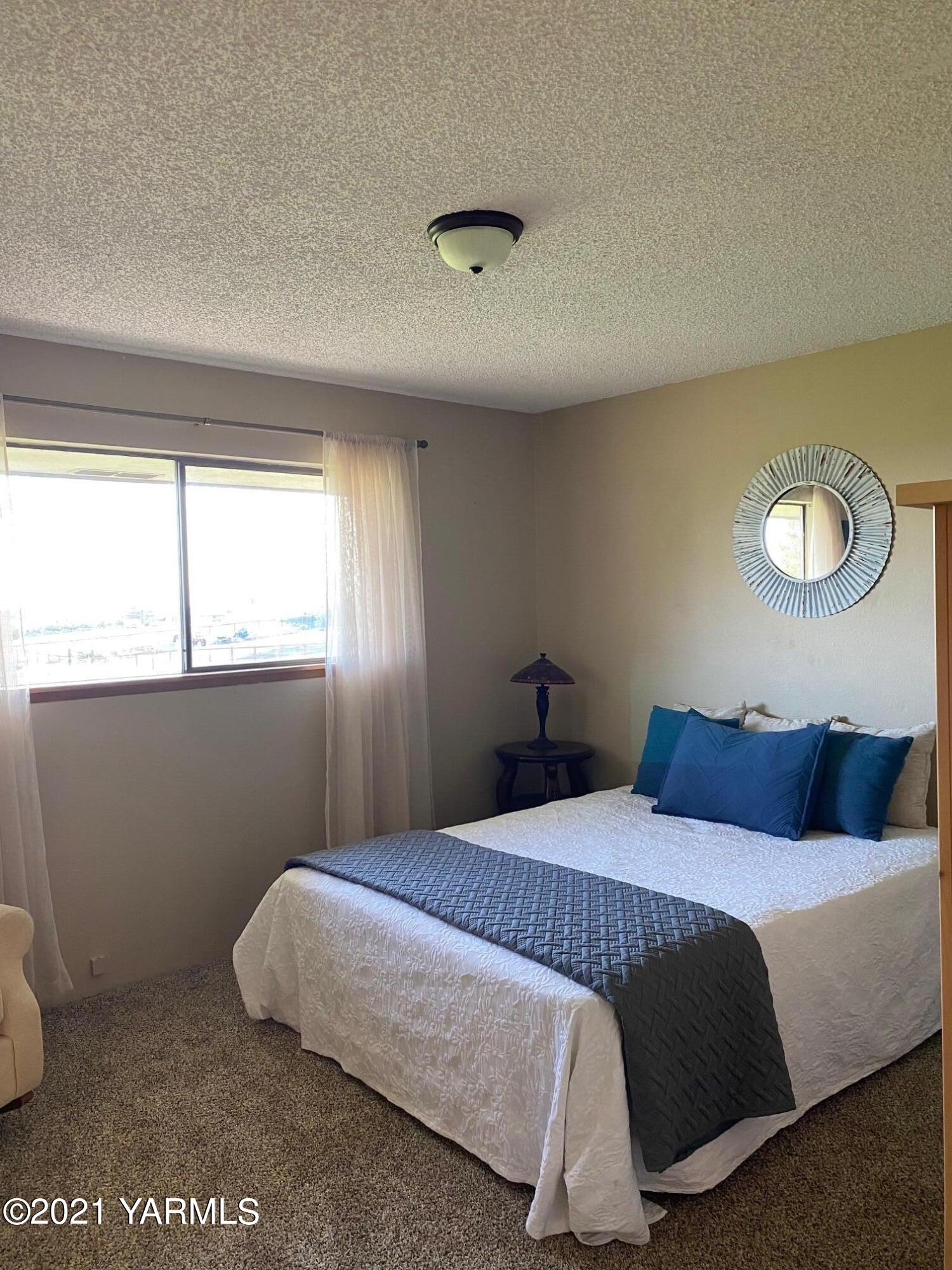 320 Bliss Road Zillah, WA 98953 - Photo 17 of 33 a bedroom with a bed and window