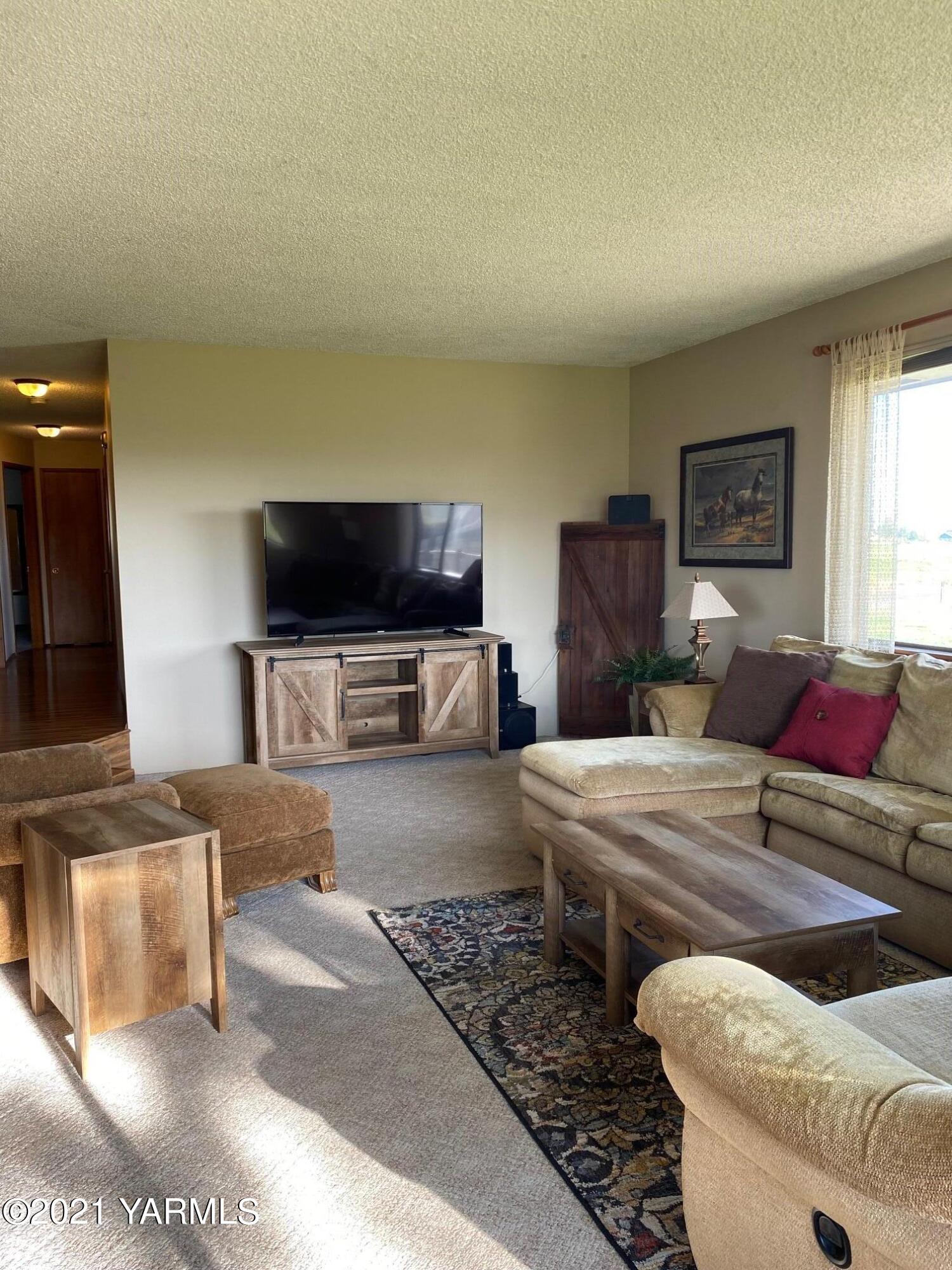 320 Bliss Road Zillah, WA 98953 - Photo 5 of 33 a living room with furniture and a flat screen tv