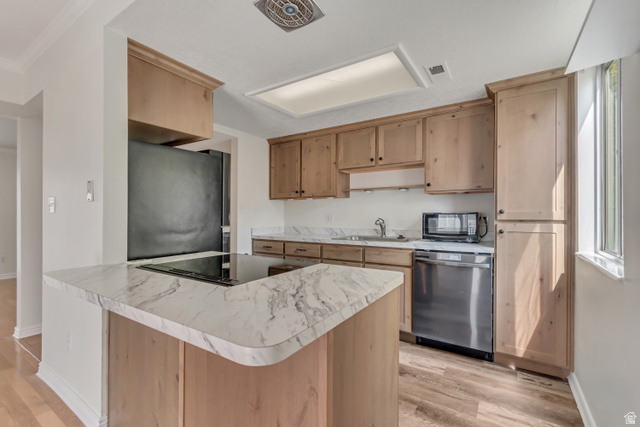 653 South 500 West, Unit 1 Provo, UT 84601 - Photo 7 of 17 Kitchen featuring wood-finish cabinetry, white countertops with gray veining, a stainless steel dishwasher, a built-in microwave, and wood-finish flooring