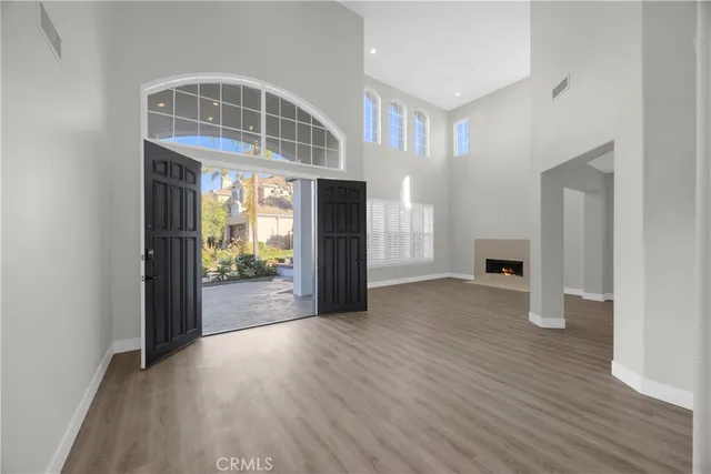 an empty room with wooden floor and fireplace