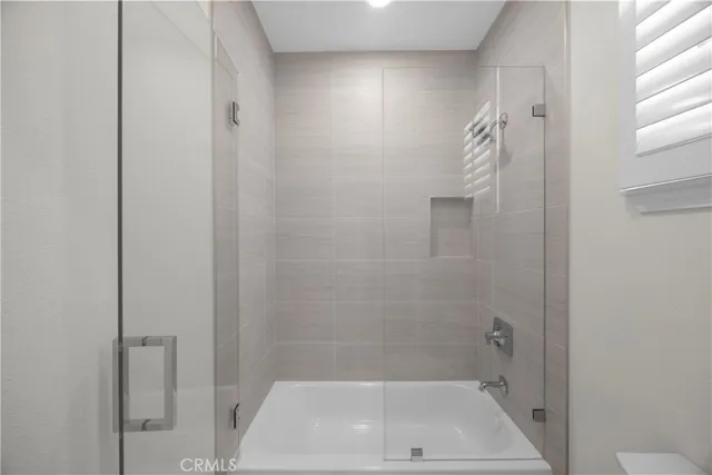 a bathroom with a shower and a toilet