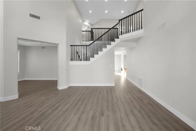 a view of a yard with plants and trees