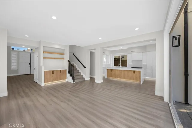 a view of a kitchen with wooden floor and stairs